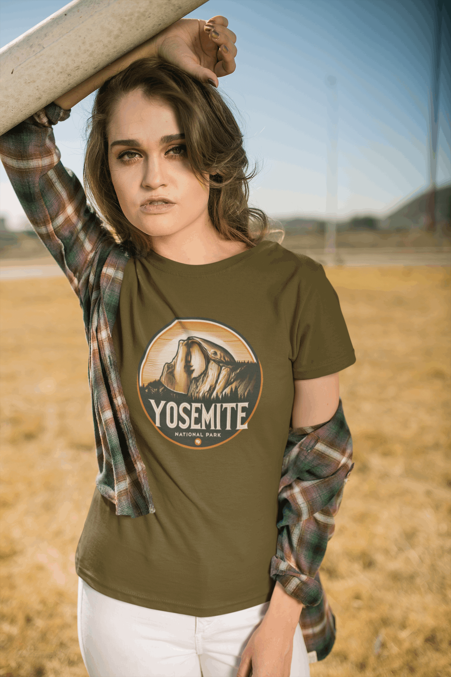 Woman in California wearing Wyld Peak Yosemite Half Dome organic cotton tee in green.