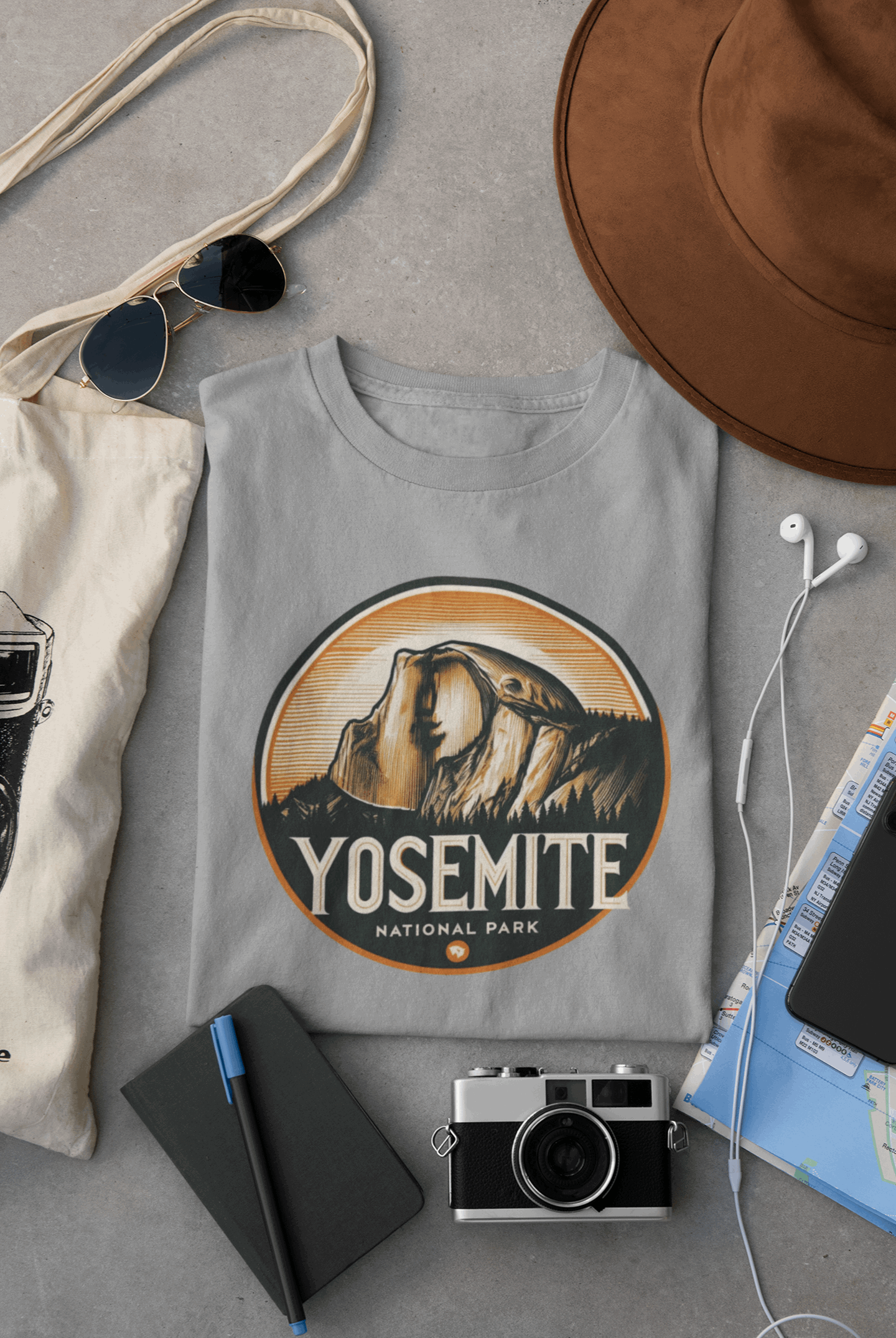 Wyld Peak Yosemite Half Dome organic cotton tee in grey laid flat on desk.