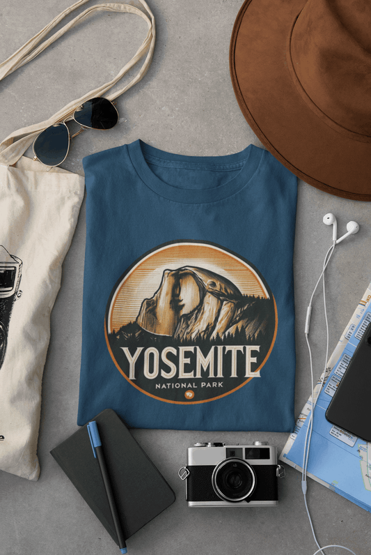 Wyld Peak Yosemite Half Dome organic cotton tee in navy laid flat on desk.