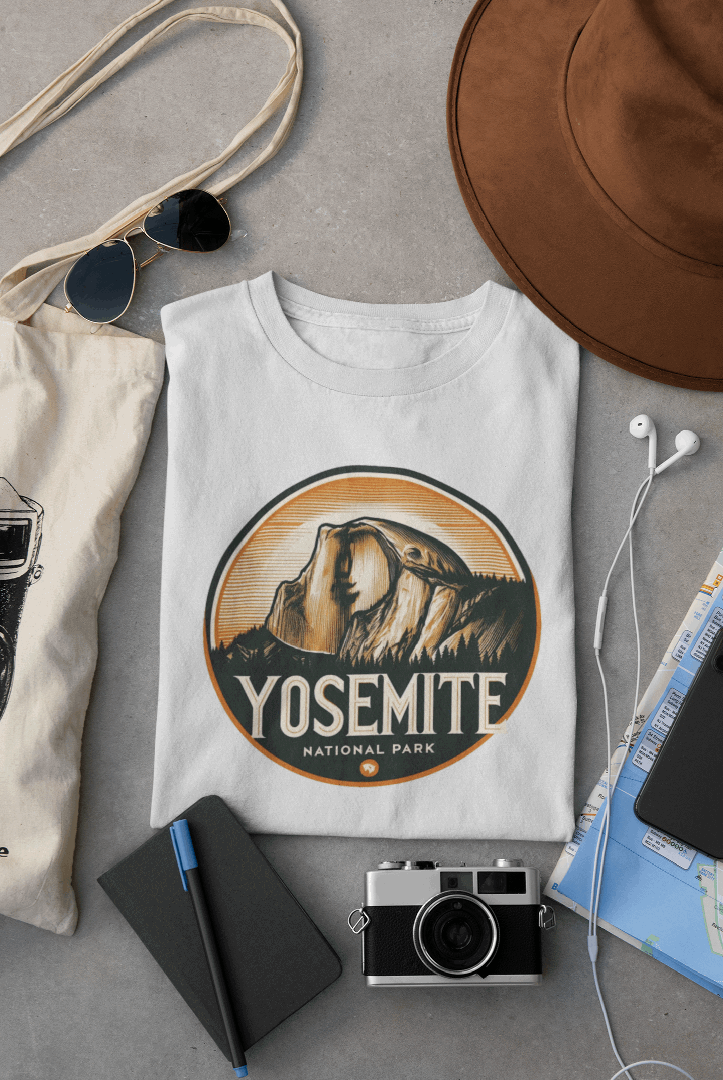 Wyld Peak Yosemite Half Dome organic cotton tee in white laid flat on desk.