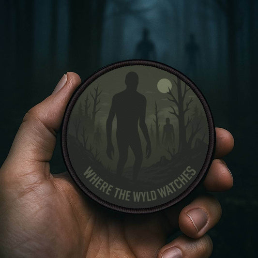 Wyld Peak Shadow People patch being held in a creepy forest at dusk