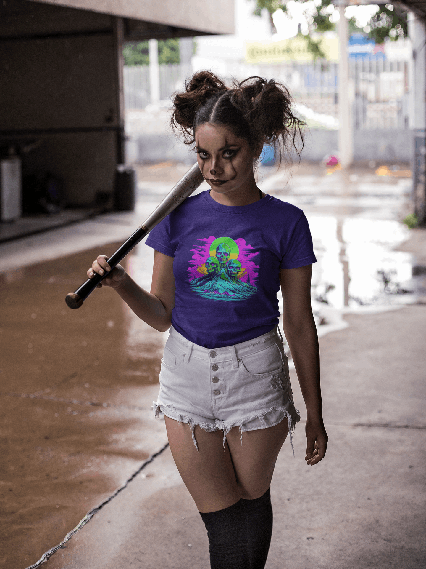 Woman in purple Wyld Peak Zombie Skull organic skater women's T-shirt dressed for Halloween.