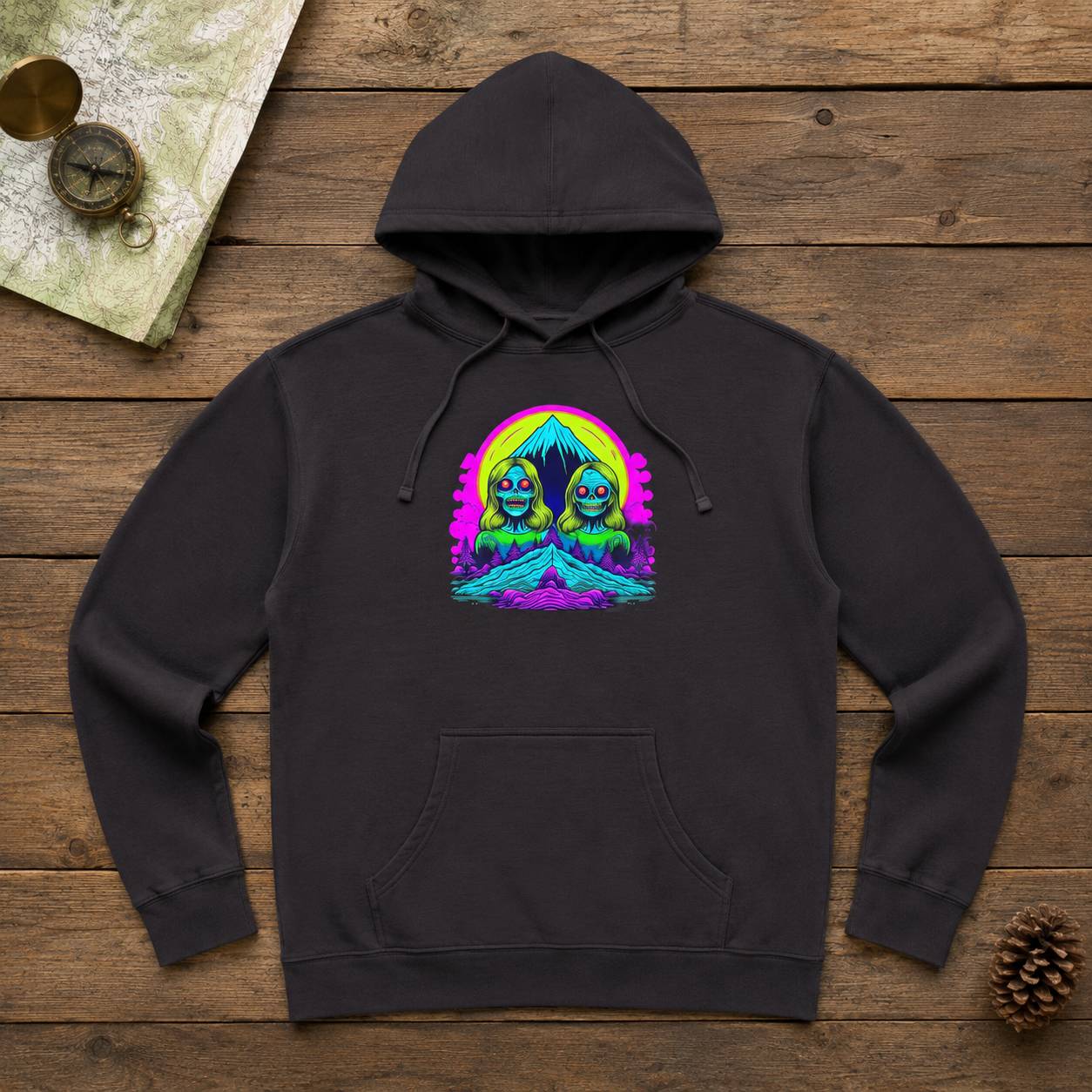 Black hoodie with a colorful graphic design on a wooden surface