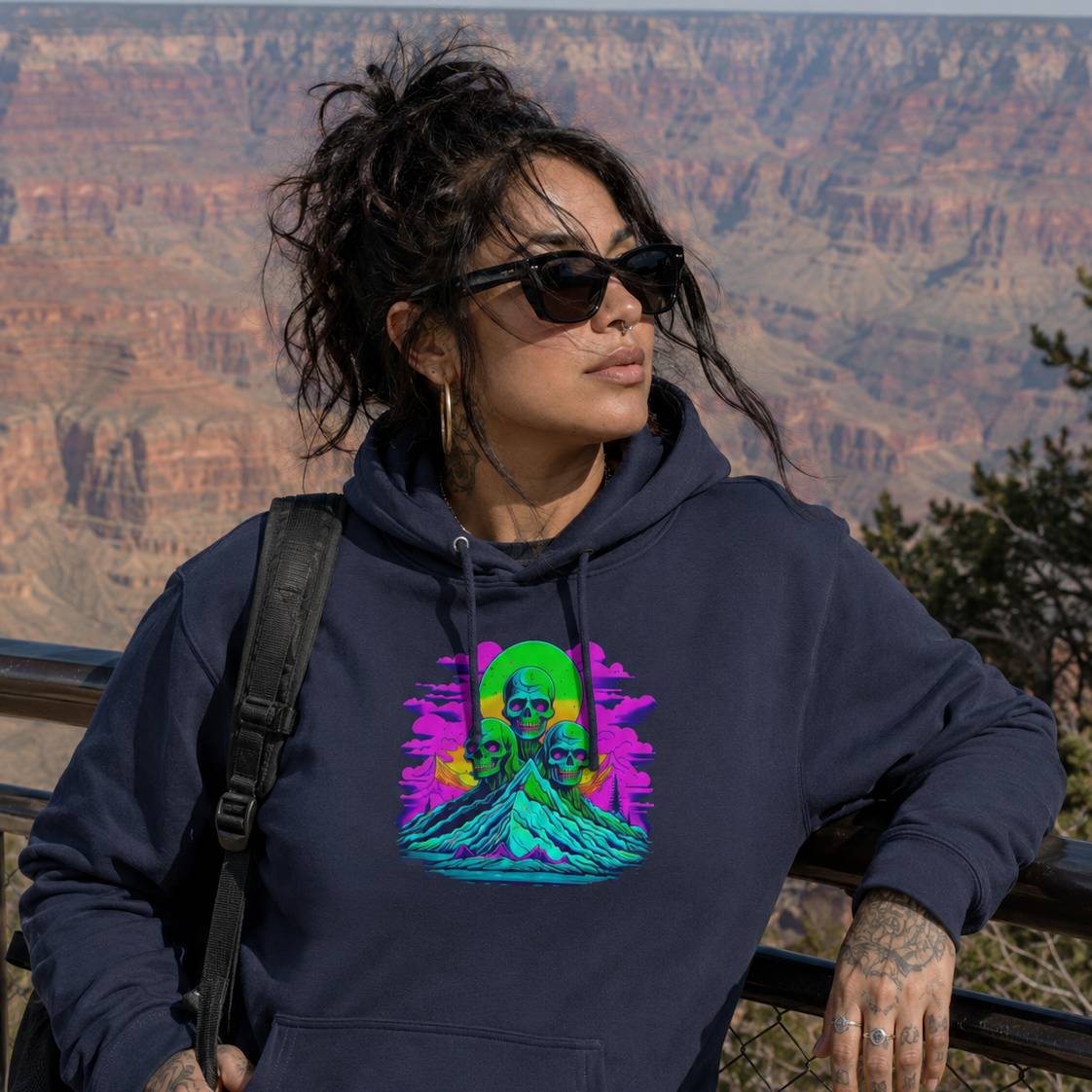 Person wearing a hoodie with a colorful graphic design in front of the Grand Canyon.