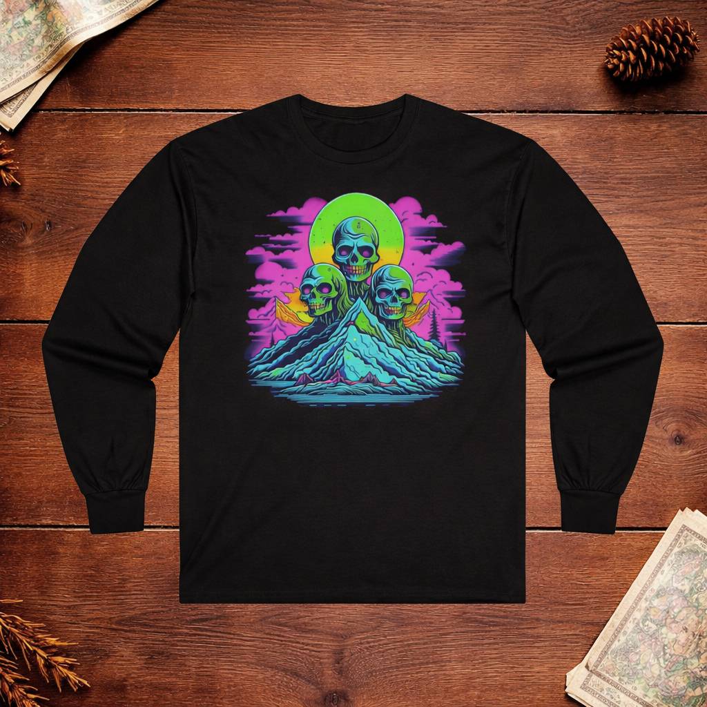 Black long-sleeve shirt with a colorful graphic of skulls and mountains on a wooden surface.