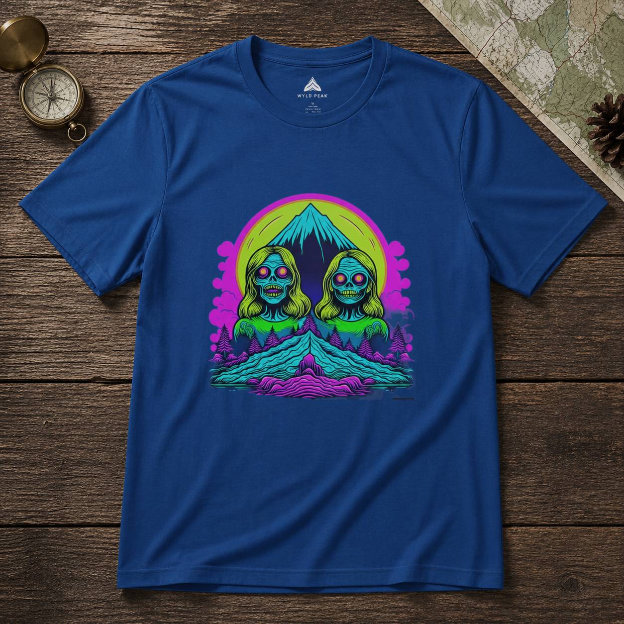 Blue t-shirt with a colorful graphic design on a wooden surface