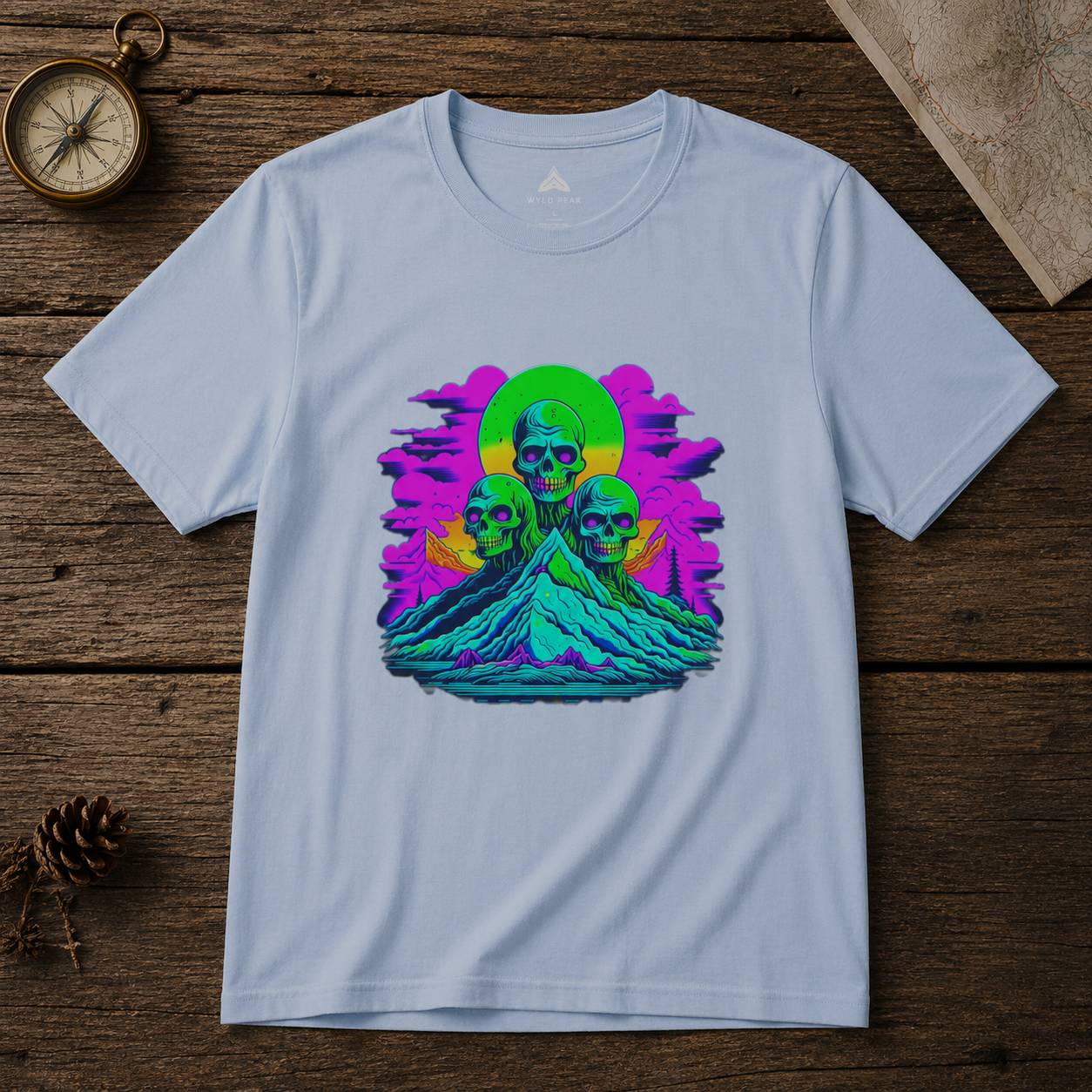 White t-shirt with colorful skull design on a wooden surface