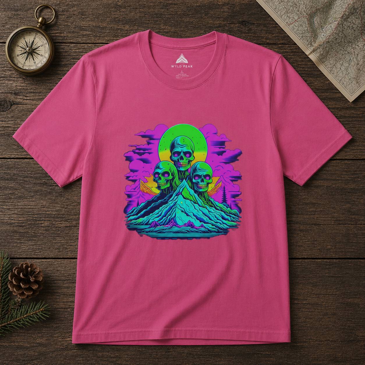 Pink t-shirt with a colorful graphic design on a wooden surface