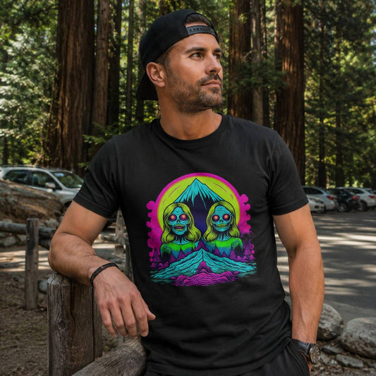 Man wearing a black t-shirt with a colorful graphic design in a forest setting