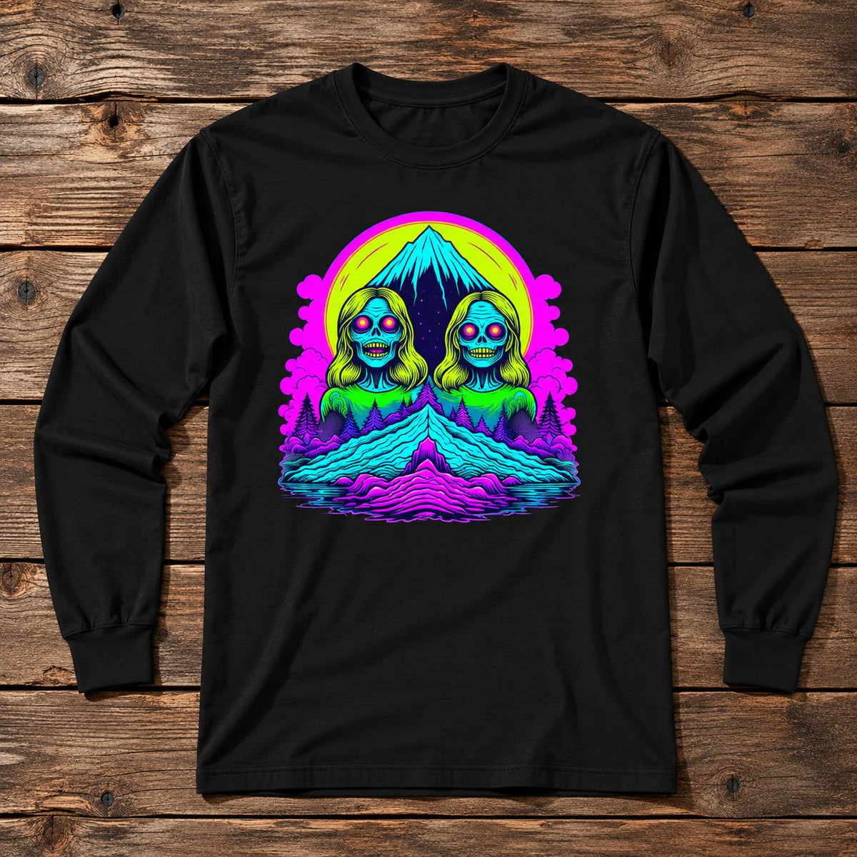 A black long-sleeve t-shirt with a vibrant, colorful graphic print on the chest, displayed flat against a rustic wooden plank background.