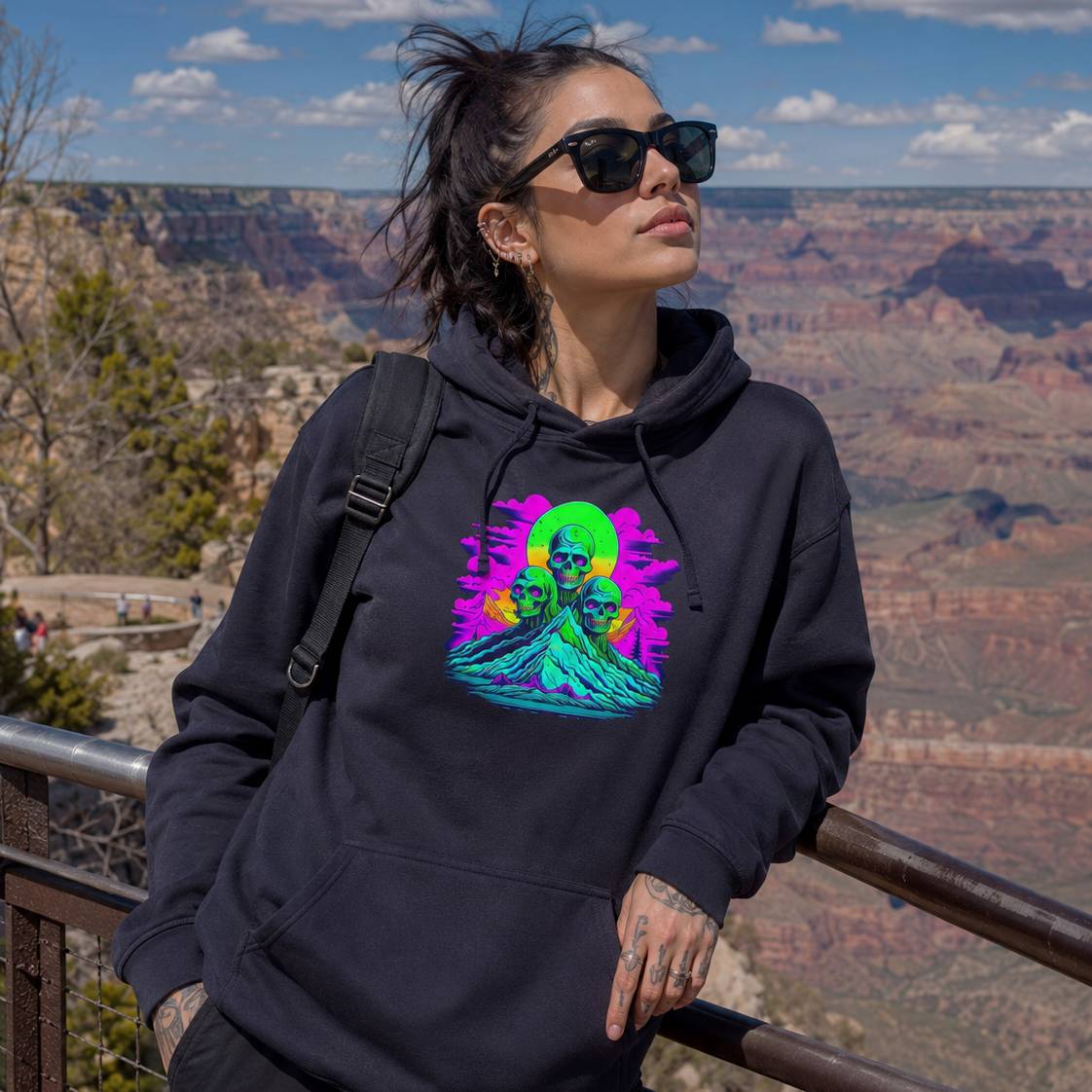 Person wearing a black hoodie with a colorful graphic design at the Grand Canyon.