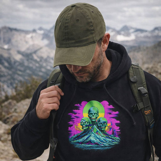 Man wearing a black hoodie with a colorful graphic design in a mountainous landscape